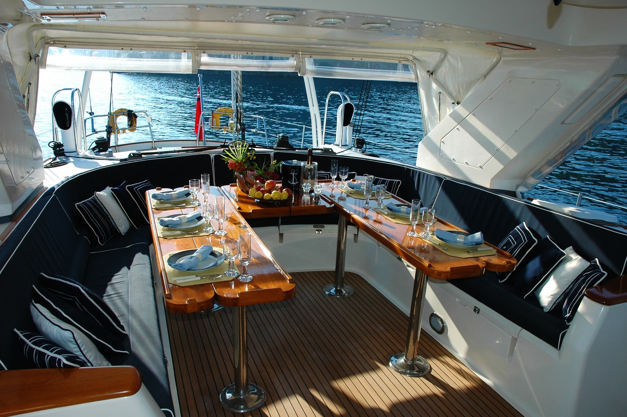 boat interior designer on yacht with table set for meal