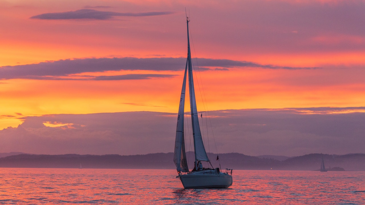 award winning sailboat at dusk with sails up