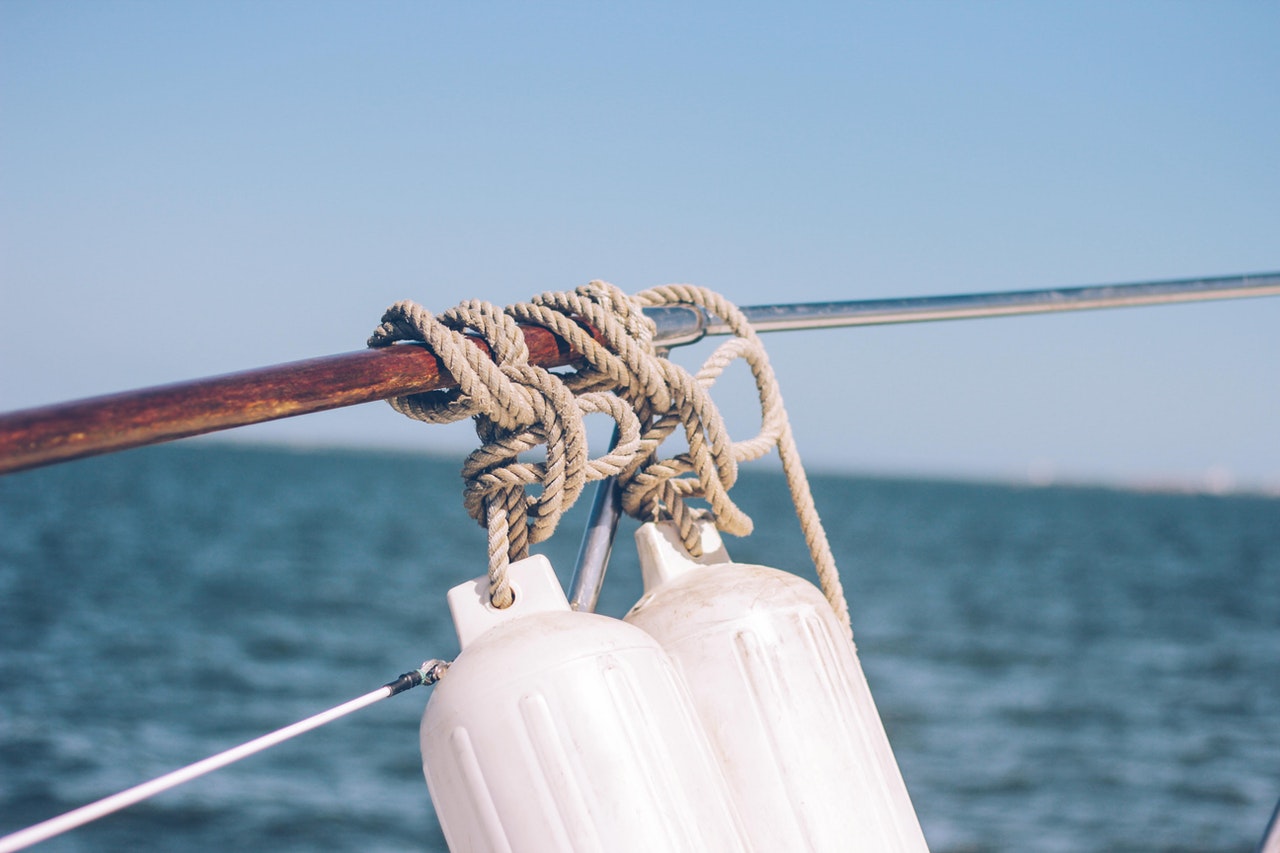 boating products and equipment tied to boat rail on the water