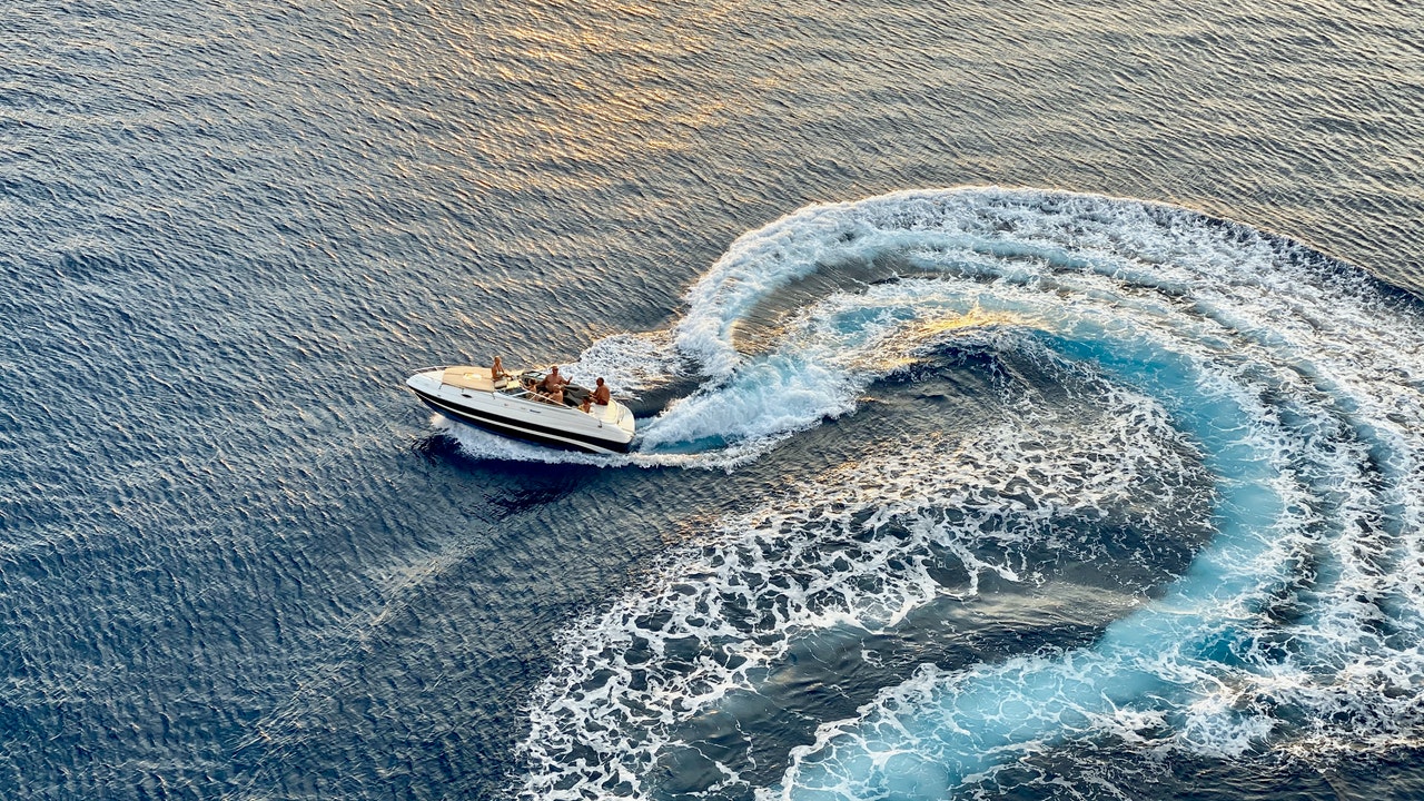 top ranked motorboat cruising through the water making a wakeboard surf wake