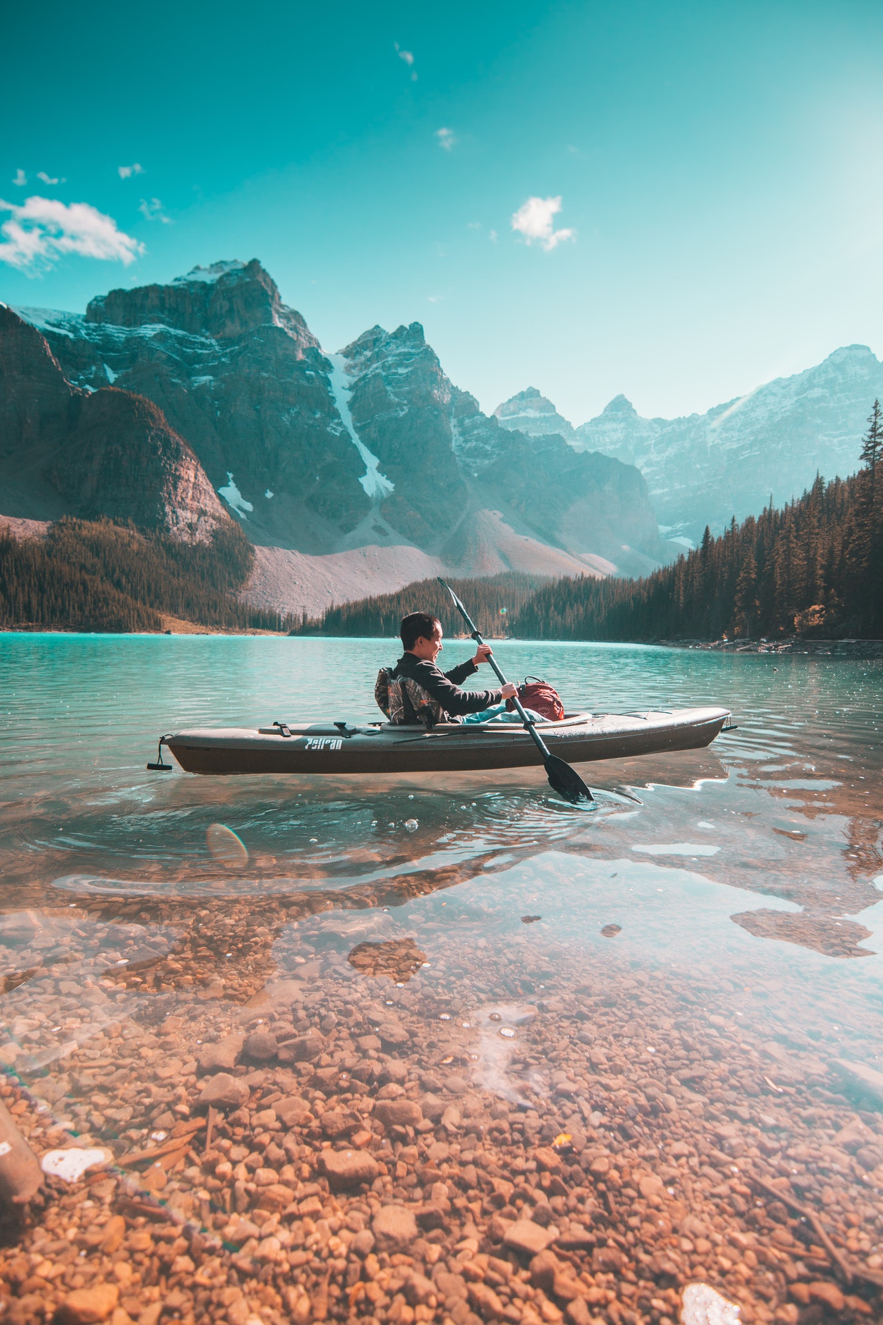 peaceful kayaker using the best kayak stabilizers to help keep balance on serene lake
