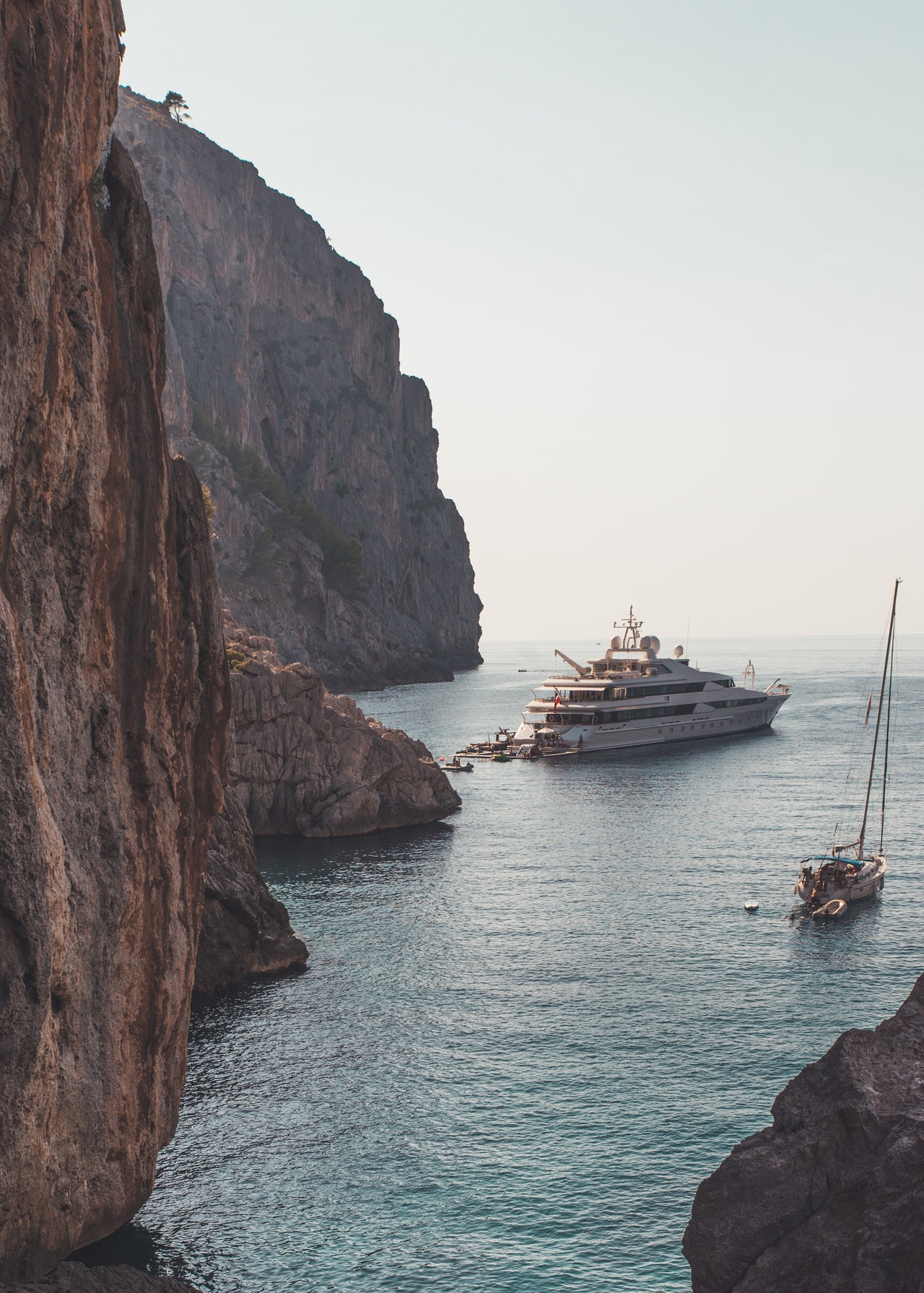 beautiful yachts off a rocky coast that people love to read about in the best yacht magazines