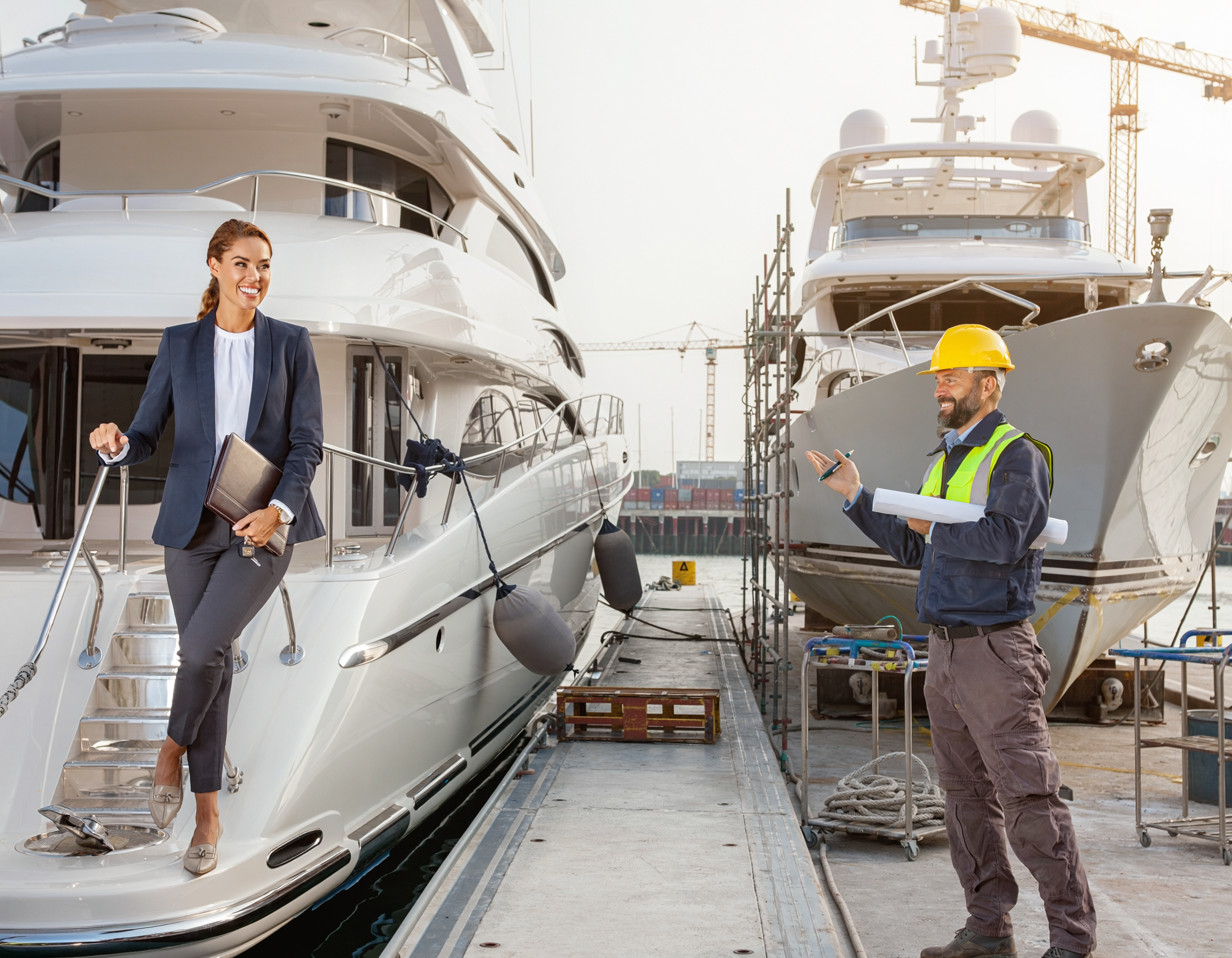 broker and yacht builder standing next to yachts