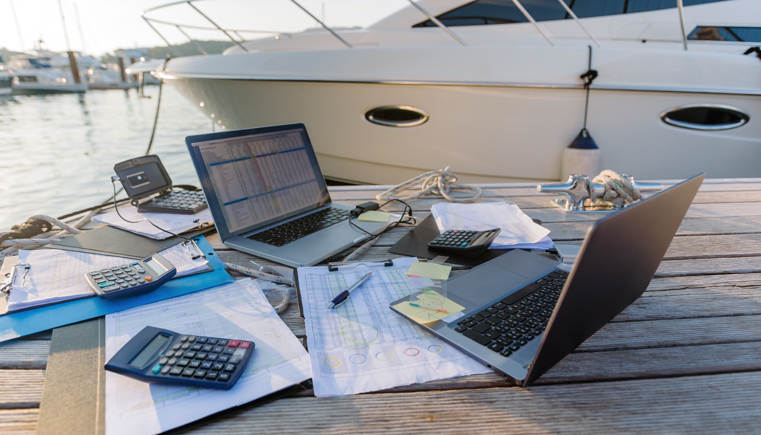 calculators and spreadsheets near dock by yacht